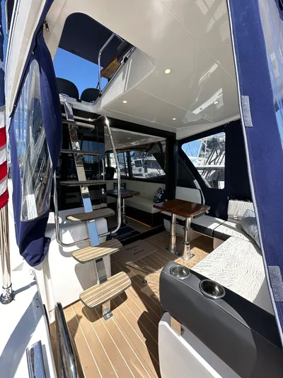  Yacht Photos Pics 2024 Bavaria R40 yacht interior with modern seating, table, and staircase.