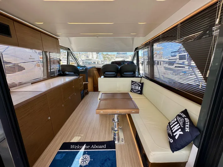  Yacht Photos Pics Luxurious interior of 2024 Bavaria R40 yacht with modern seating and elegant wood finishes.