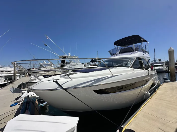  Yacht Photos Pics 2024 Bavaria R40 yacht docked at marina under clear blue sky.