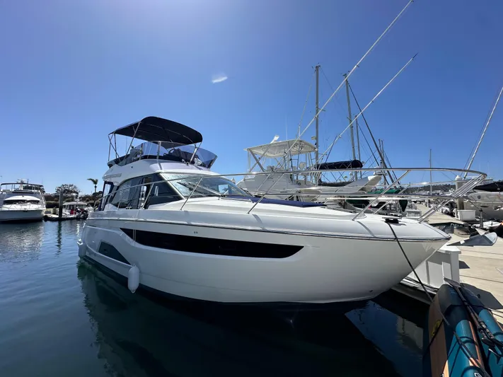  Yacht Photos Pics 2024 Bavaria R40 yacht docked at marina under clear blue sky.