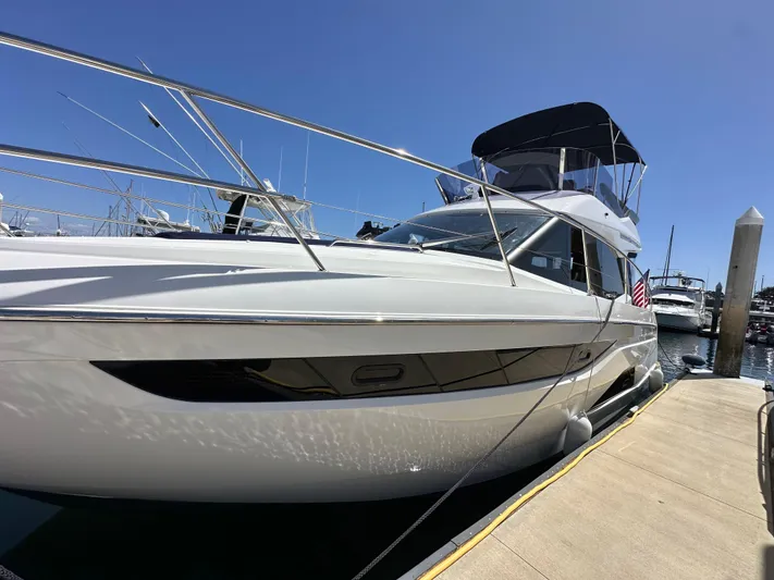  Yacht Photos Pics 2024 Bavaria R40 yacht docked at marina under clear blue sky.