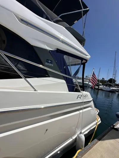  Yacht Photos Pics 2024 Bavaria R40 yacht docked at marina with American flag.