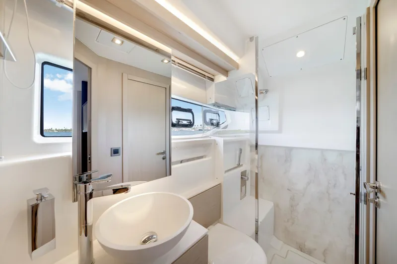  Yacht Photos Pics Luxurious bathroom interior of 2024 Jeanneau DB/43 OB yacht, featuring modern fixtures and elegant design.
