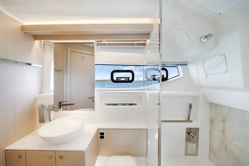  Yacht Photos Pics Luxurious bathroom interior of 2024 Jeanneau DB/43 OB yacht with modern fixtures.