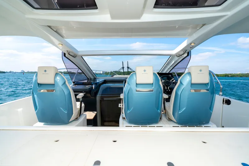  Yacht Photos Pics 2024 Jeanneau DB/43 OB boat interior with blue captain seats and panoramic water view.