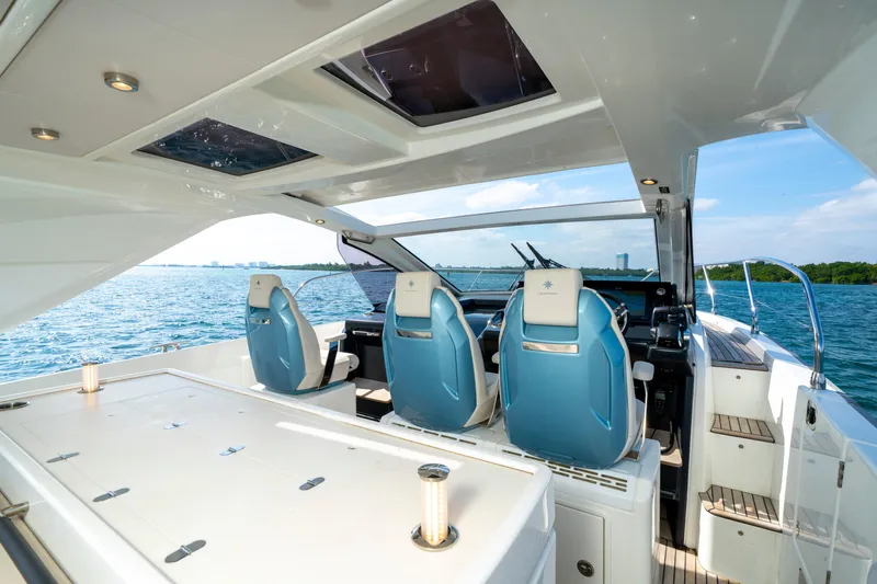  Yacht Photos Pics 2024 Jeanneau DB/43 OB yacht interior with blue seats and ocean view.