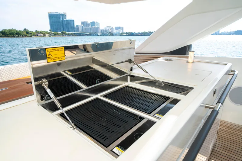  Yacht Photos Pics Outdoor grill on 2024 Jeanneau DB/43 OB yacht, with city skyline and water view.
