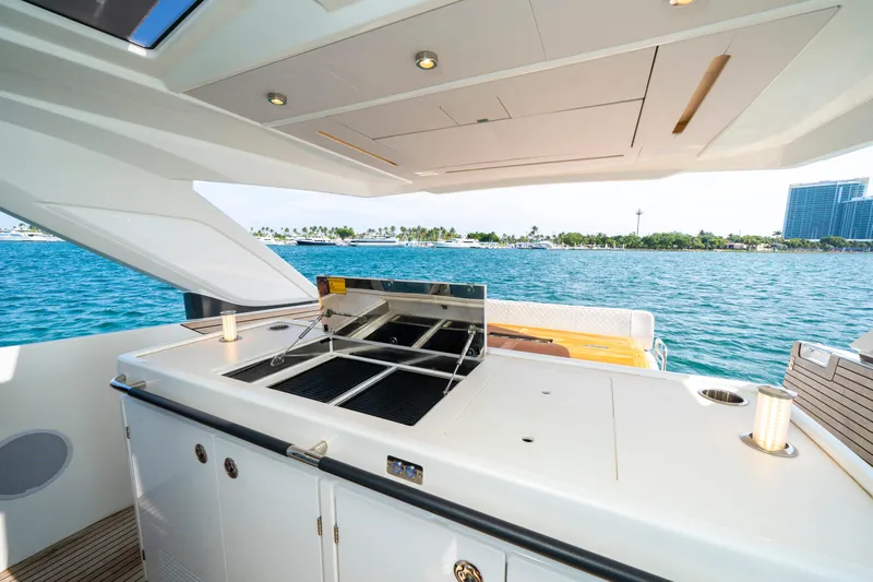  Yacht Photos Pics 2024 Jeanneau DB/43 OB yacht with outdoor kitchen, overlooking serene blue waters.