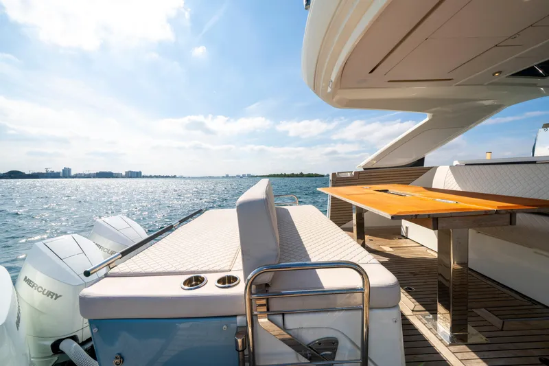  Yacht Photos Pics 2024 Jeanneau DB/43 OB yacht deck with seating, table, and Mercury outboard motors on a sunny day.