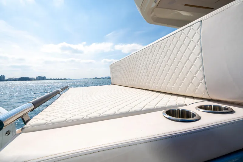  Yacht Photos Pics Luxurious seating on 2024 Jeanneau DB/43 OB yacht with ocean view and cup holders.