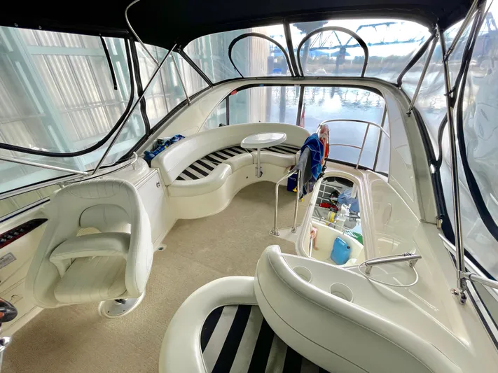 Seaduced Yacht Photos Pics 2006 Meridian 341 Sedan interior with seating, table, and helm in a marina setting.
