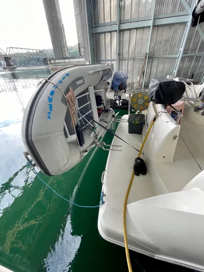 Seaduced Yacht Photos Pics 2006 Meridian 341 Sedan docked with inflatable boat, in covered marina.