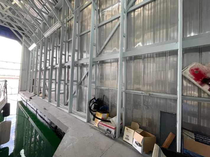 Seaduced Yacht Photos Pics Indoor boat storage with metal walls, featuring a 2006 Meridian 341 Sedan.