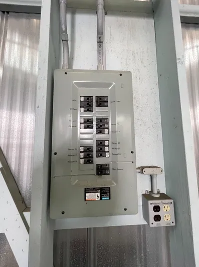 Seaduced Yacht Photos Pics Electrical panel with multiple circuit breakers on a wall, near a power outlet.