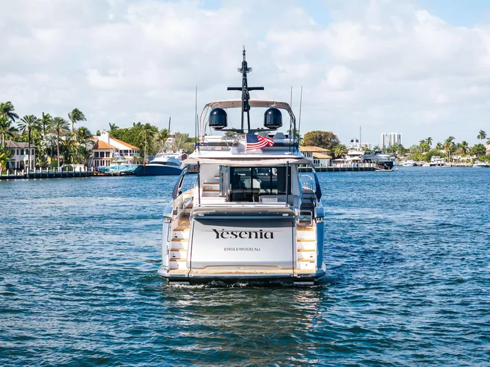 Yesenia Yacht Photos Pics 2024 Azimut S8 yacht cruising on a scenic waterway with palm trees and houses.