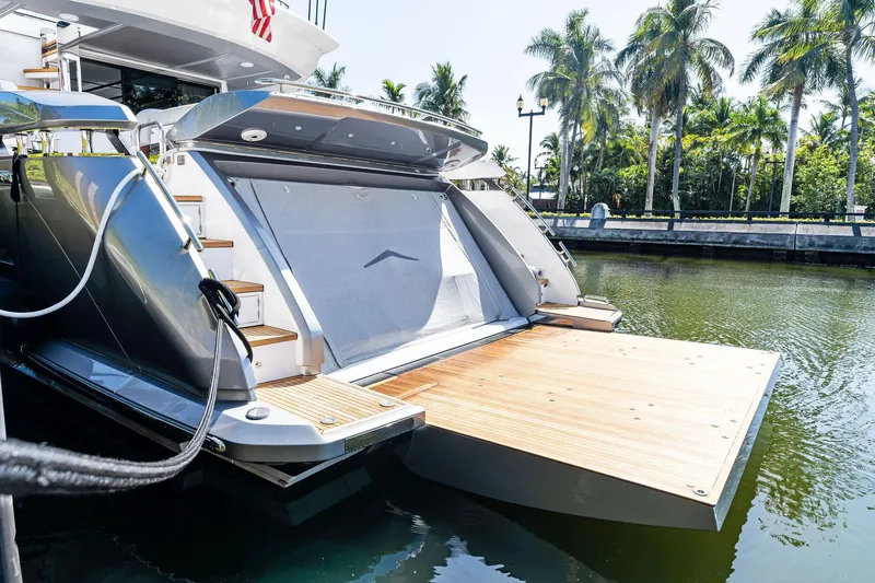 Yesenia Yacht Photos Pics 2024 Azimut S8 yacht with open swim platform, docked near palm trees.