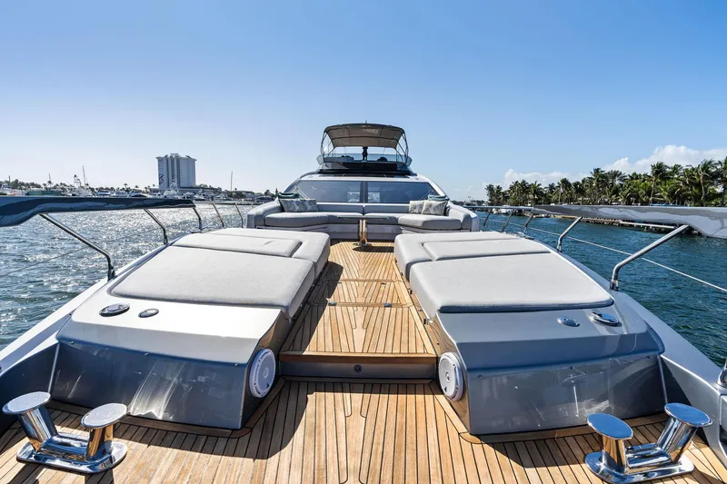 Yesenia Yacht Photos Pics 2024 Azimut S8 yacht with sun loungers on deck, cruising in sunny waters.