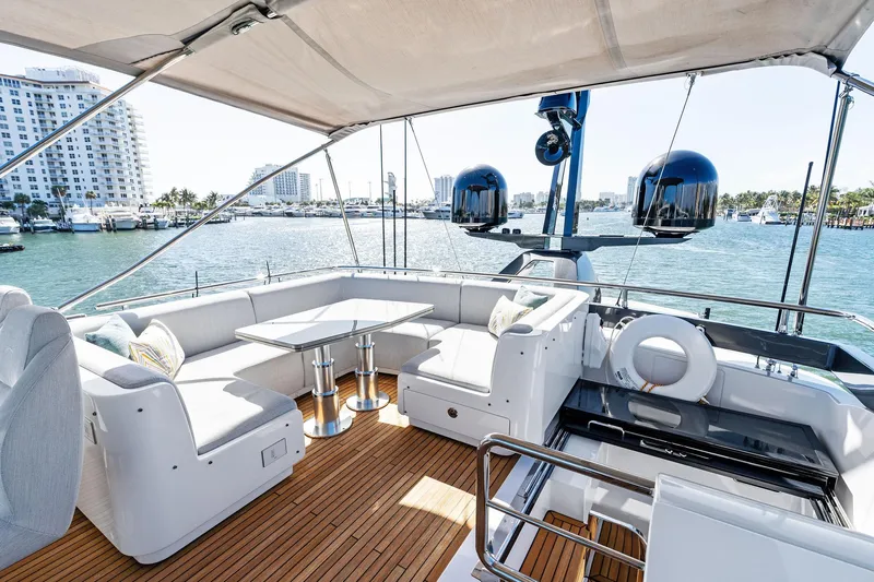 Yesenia Yacht Photos Pics Luxurious 2024 Azimut S8 yacht deck with seating, table, and ocean view.
