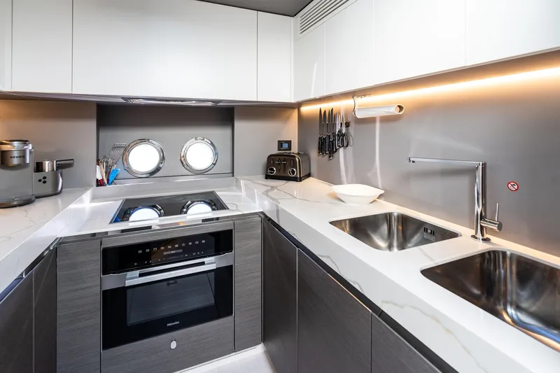 Yesenia Yacht Photos Pics Modern kitchen interior in 2024 Azimut S8 yacht with sleek appliances and dual sinks.