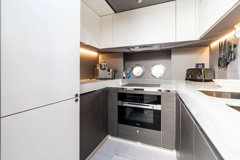 Yesenia Yacht Photos Pics Modern kitchen interior on 2024 Azimut S8 yacht, featuring sleek appliances and stylish cabinetry.