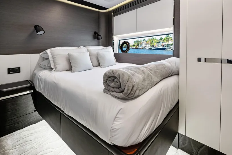 Yesenia Yacht Photos Pics Luxurious bedroom interior of 2024 Azimut S8 yacht with modern design and scenic window view.