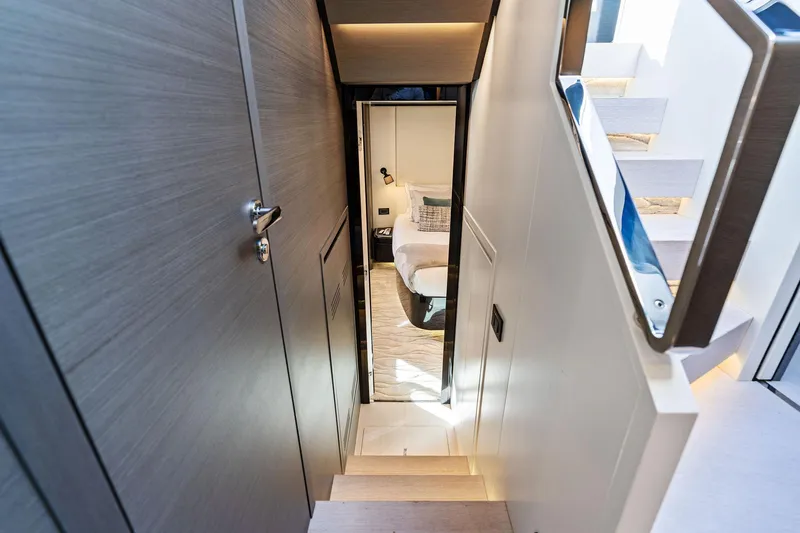 Yesenia Yacht Photos Pics 2024 Azimut S8 yacht interior, featuring modern staircase leading to a cozy bedroom.