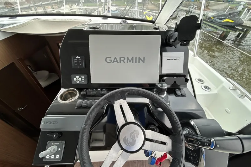  Yacht Photos Pics 2024 Beneteau Antares 11 helm with Garmin navigation and Mercury controls.