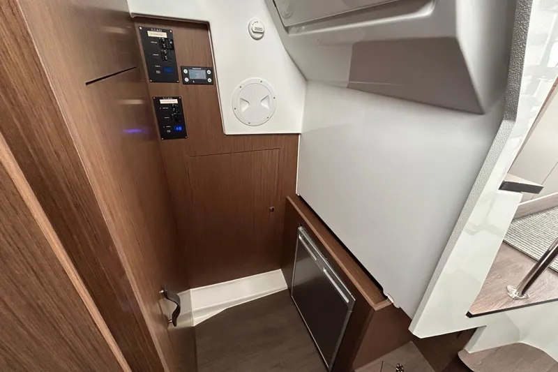  Yacht Photos Pics 2024 Beneteau Antares 11 interior with control panels and wood finish.