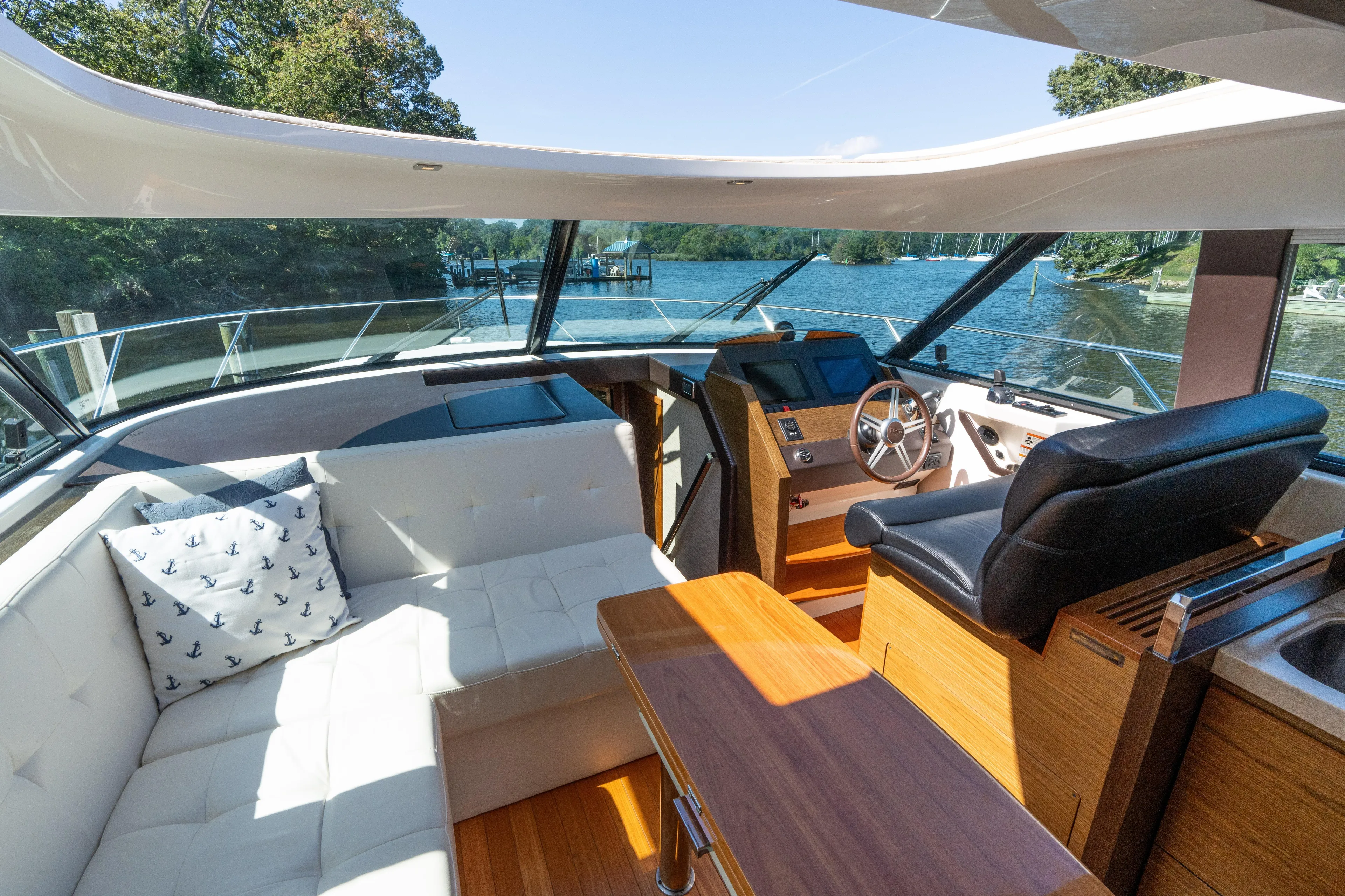 Pyrite Yacht Photos Pics Luxurious interior of 2015 Tiara Yachts C44 Coupe with helm, seating, and scenic water view.