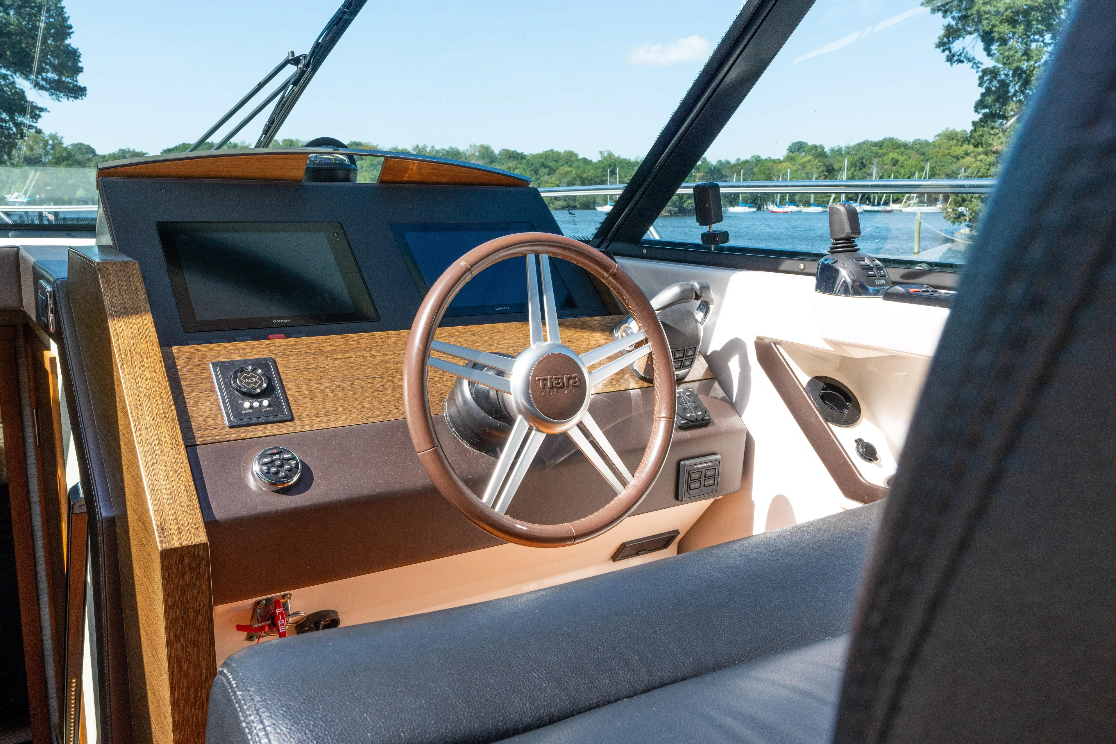Pyrite Yacht Photos Pics 2015 Tiara Yachts C44 Coupe helm with wooden dashboard and modern controls.