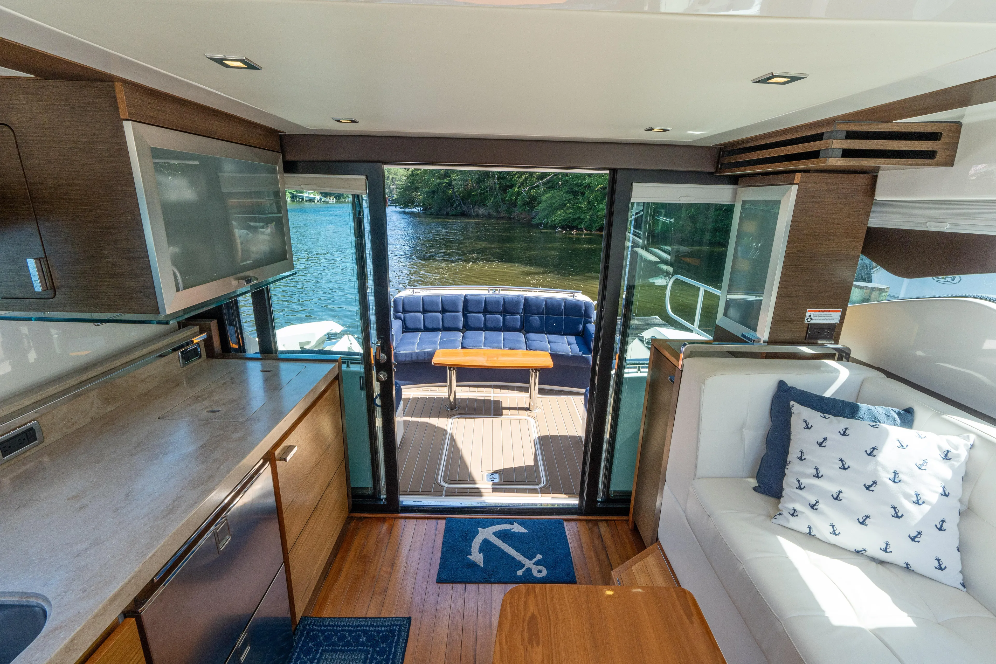 Pyrite Yacht Photos Pics Luxurious interior of 2015 Tiara Yachts C44 Coupe with elegant seating and scenic water view.