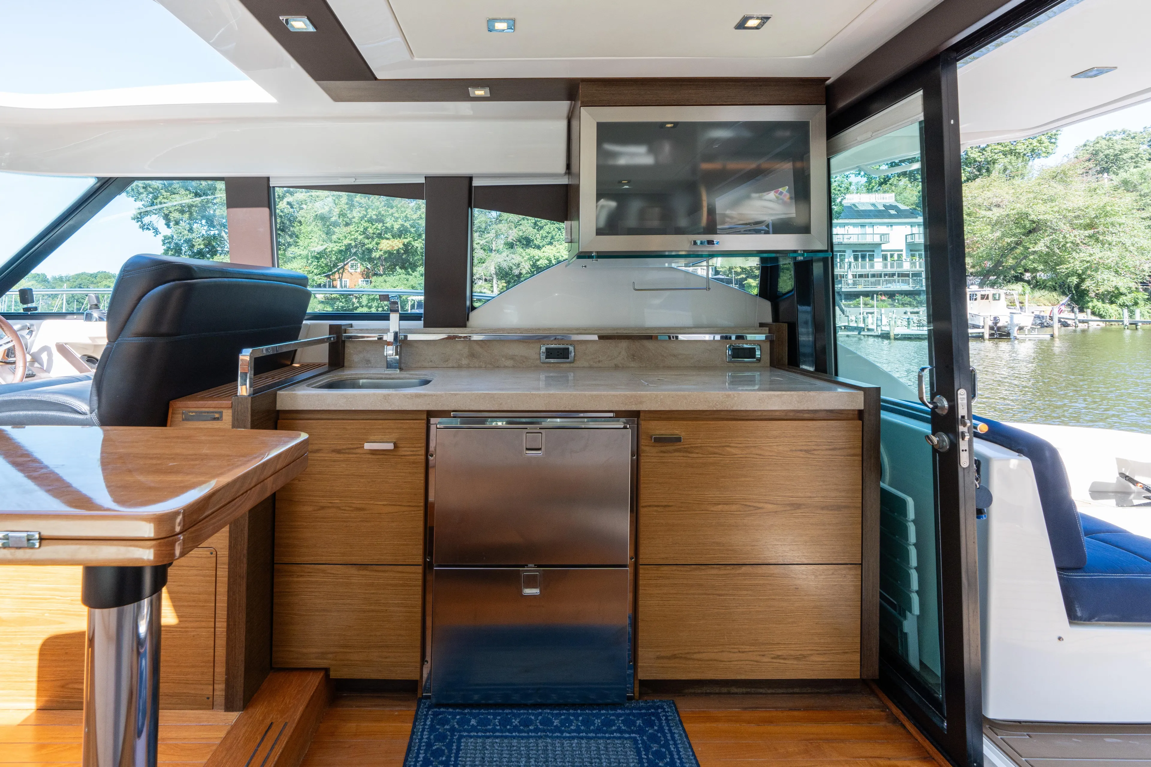 Pyrite Yacht Photos Pics Luxurious interior of 2015 Tiara Yachts C44 Coupe with modern kitchen and scenic view.