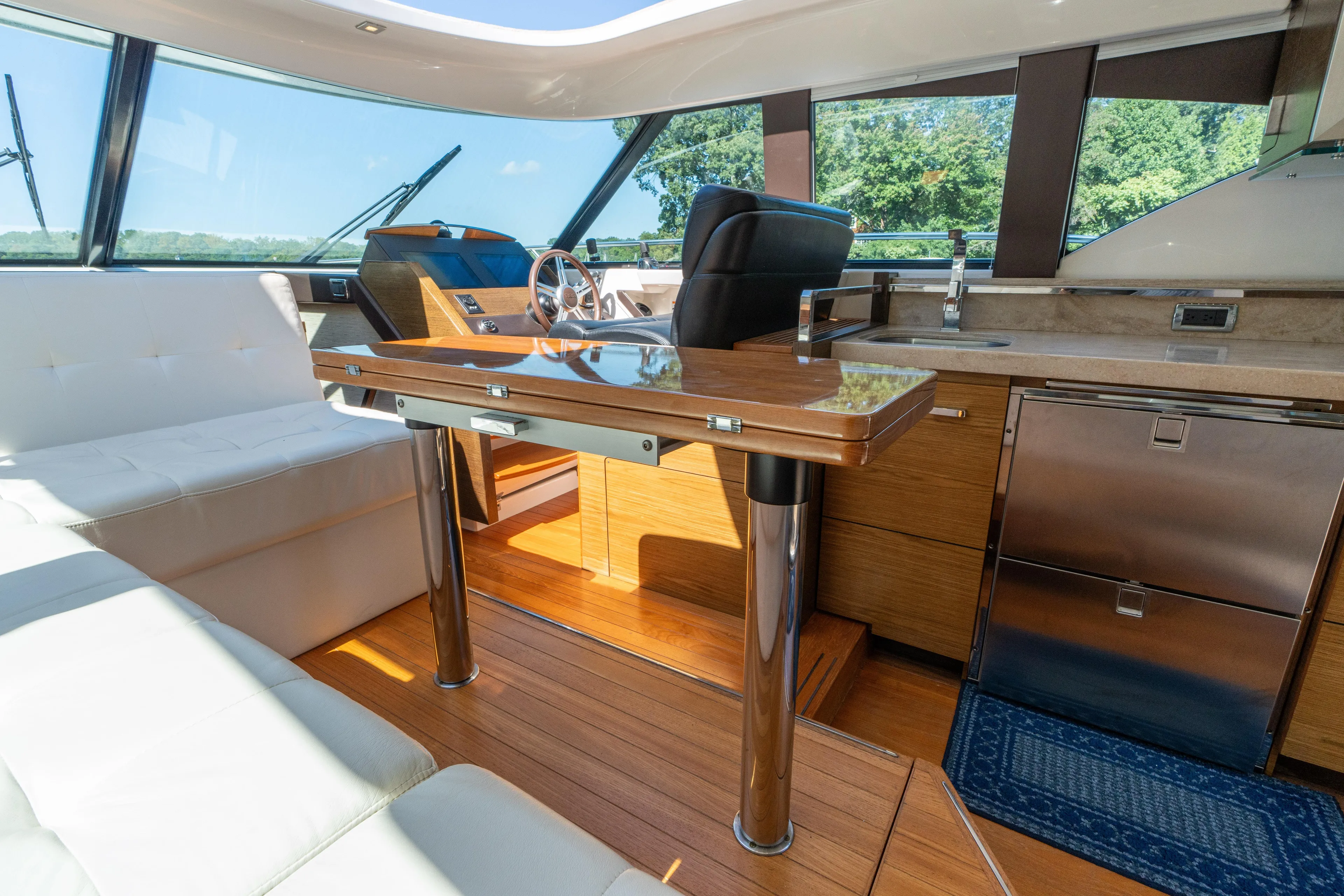 Pyrite Yacht Photos Pics Interior of 2015 Tiara Yachts C44 Coupe, featuring luxurious seating and modern helm.