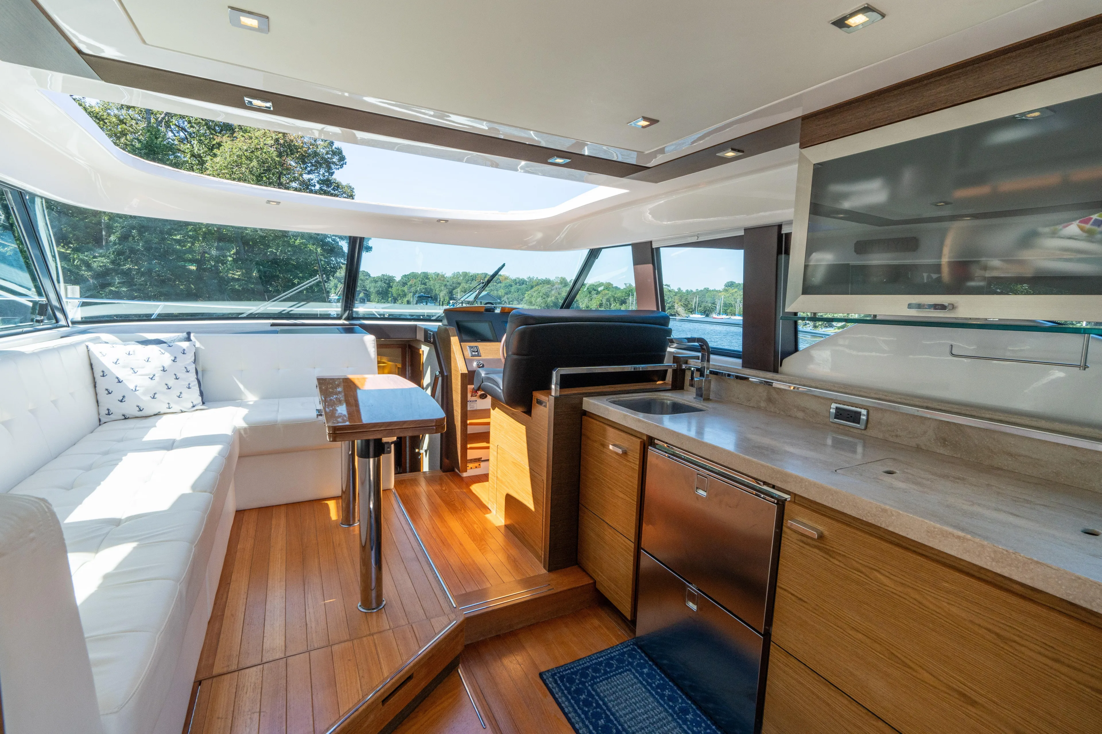Pyrite Yacht Photos Pics Luxurious interior of 2015 Tiara Yachts C44 Coupe with modern kitchen and seating area.