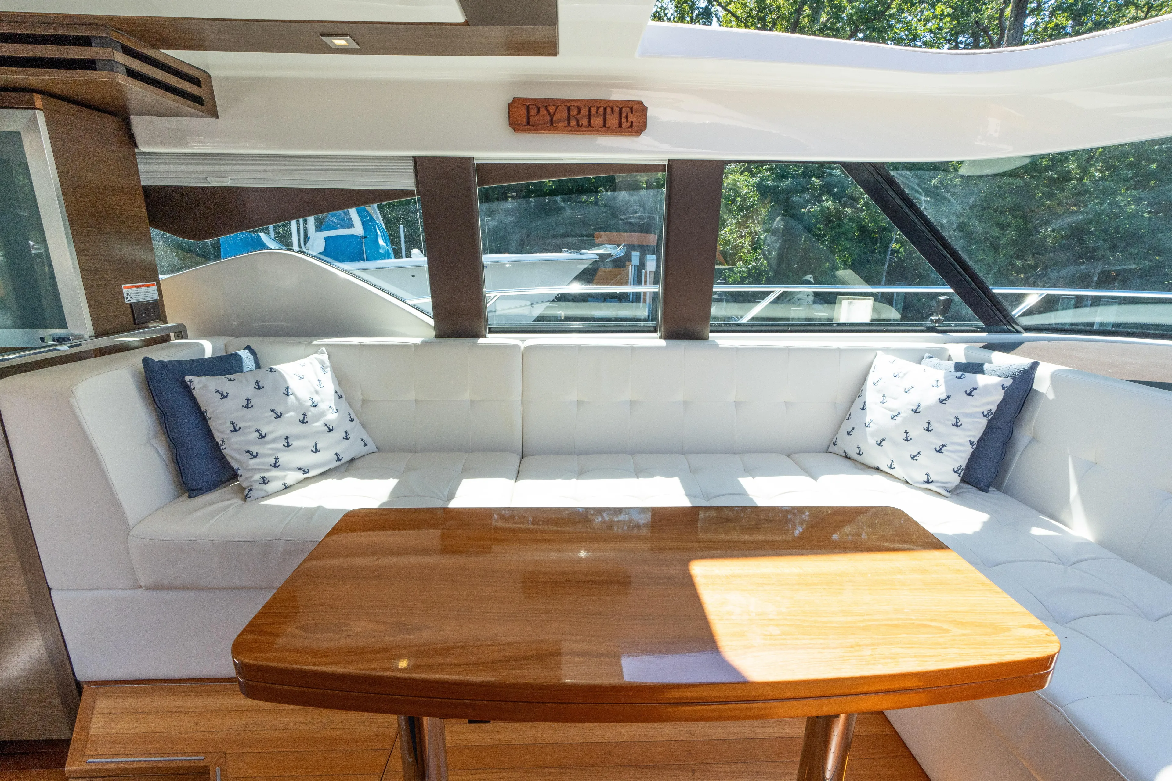 Pyrite Yacht Photos Pics Luxurious interior of 2015 Tiara Yachts C44 Coupe with elegant seating and wooden table.