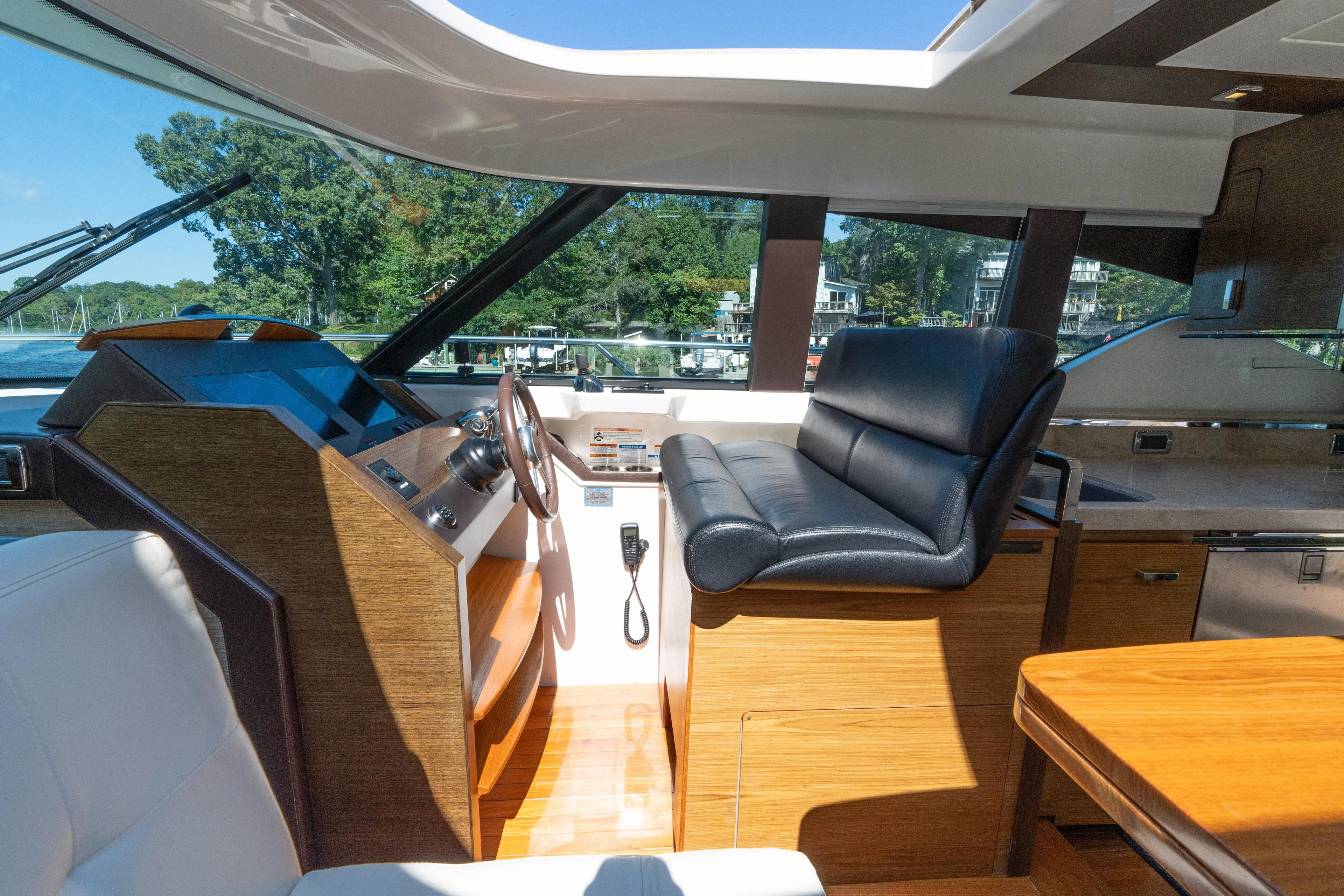 Pyrite Yacht Photos Pics Interior of 2015 Tiara Yachts C44 Coupe with luxurious helm and seating.