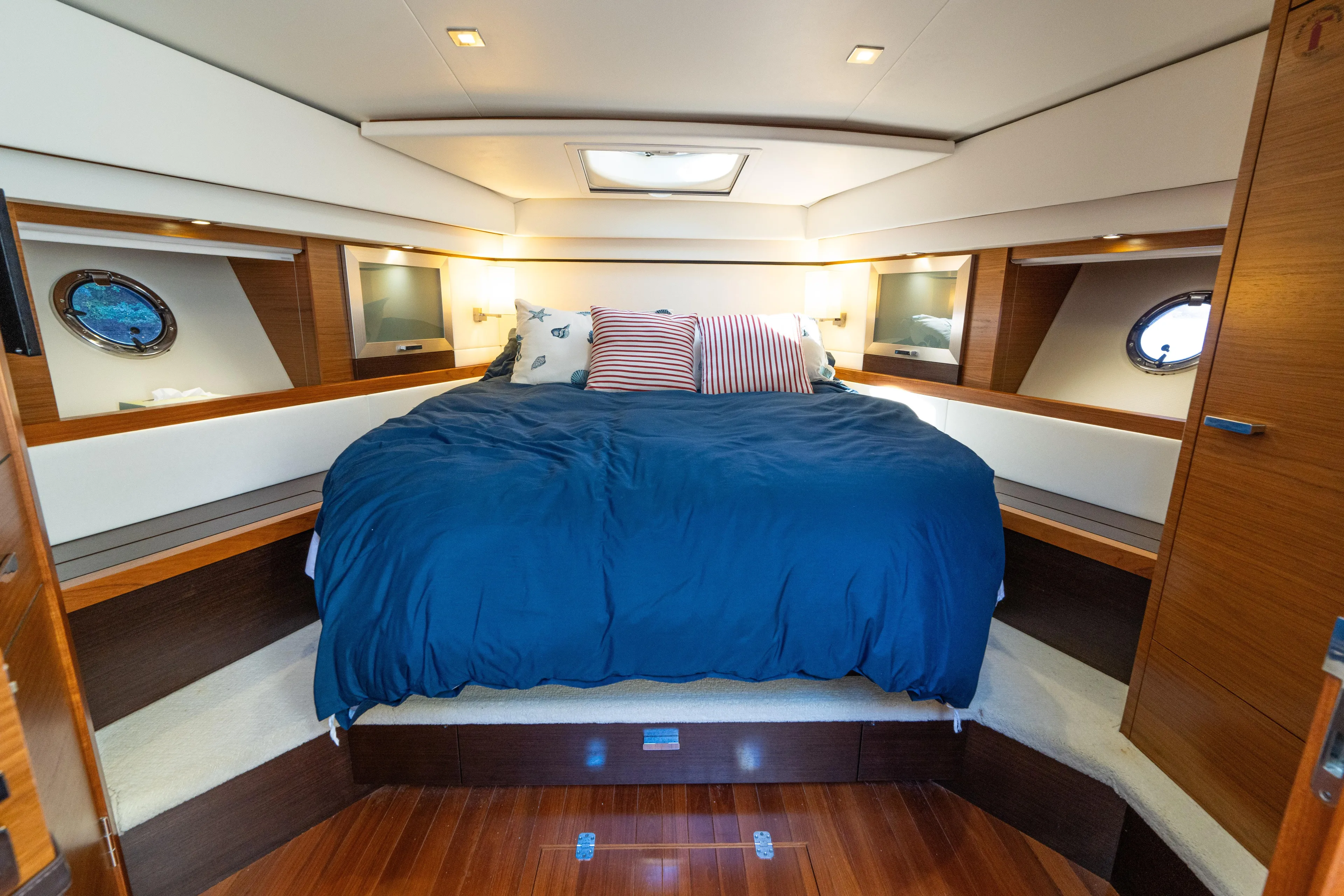 Pyrite Yacht Photos Pics Luxurious 2015 Tiara Yachts C44 Coupe cabin with cozy bed and elegant wood finishes.