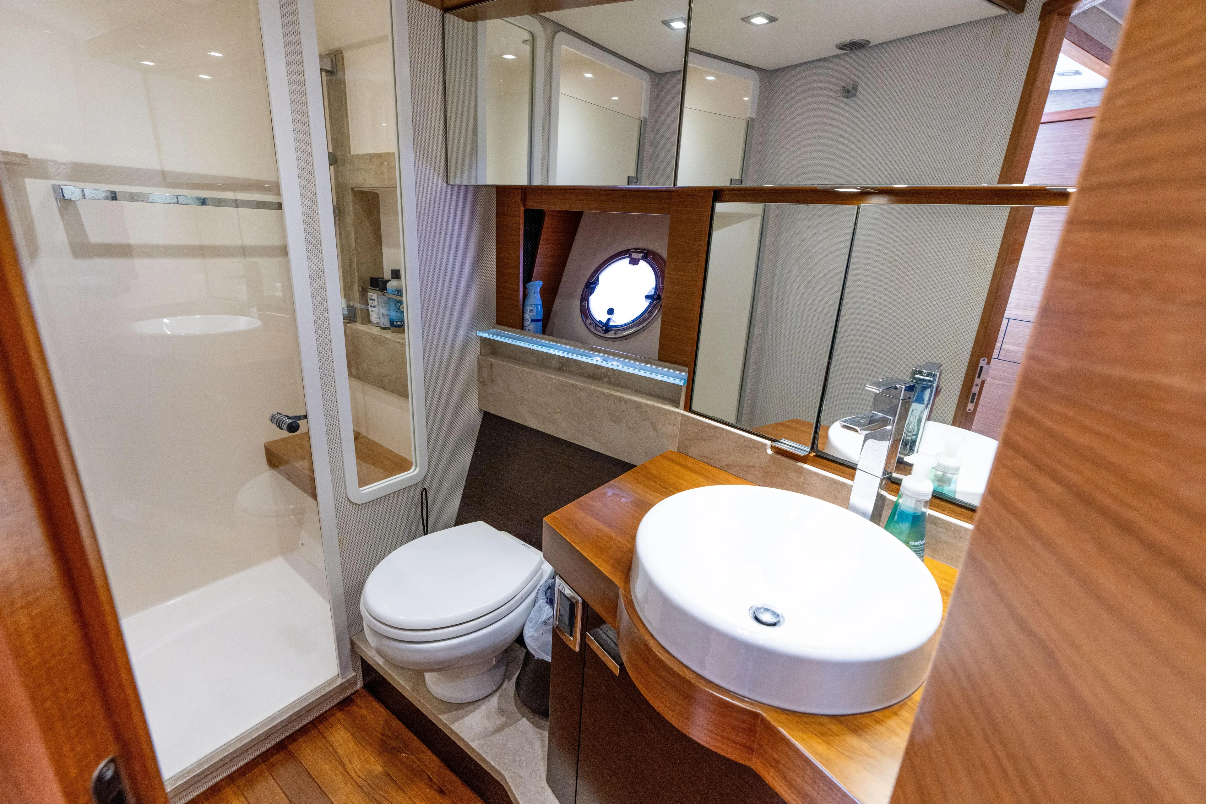 Pyrite Yacht Photos Pics Luxurious bathroom in 2015 Tiara Yachts C44 Coupe with modern fixtures and wooden accents.