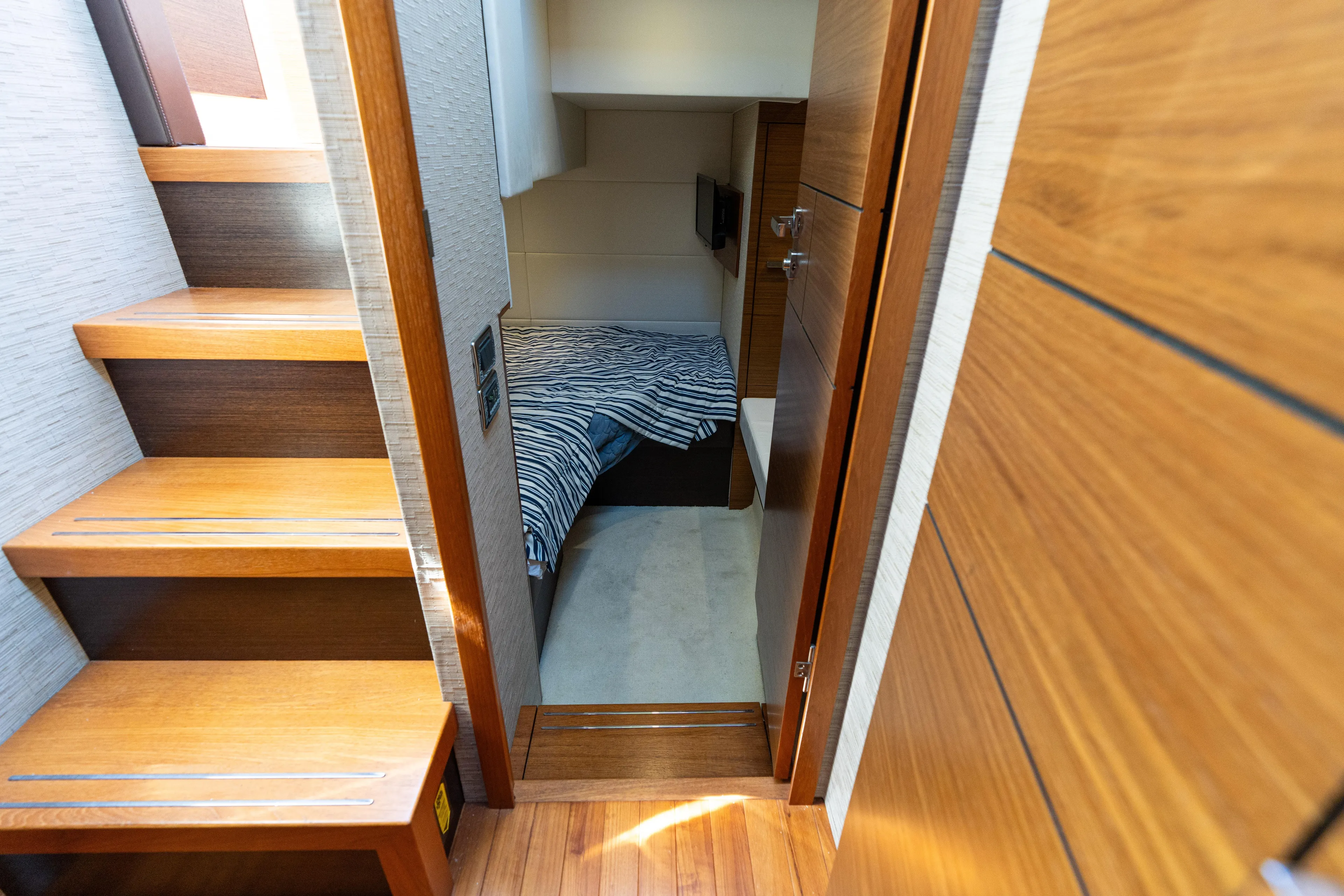 Pyrite Yacht Photos Pics Interior of 2015 Tiara Yachts C44 Coupe, featuring wooden stairs and cozy cabin.