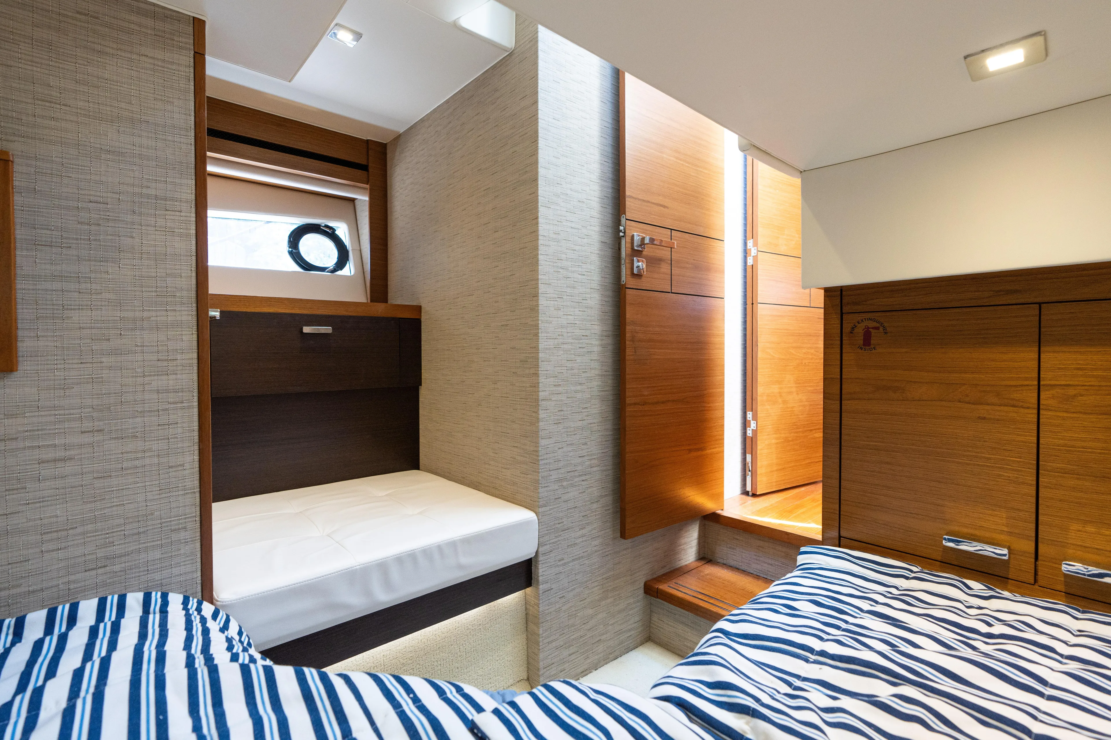 Pyrite Yacht Photos Pics Interior of 2015 Tiara Yachts C44 Coupe, featuring cozy cabin with wooden accents.