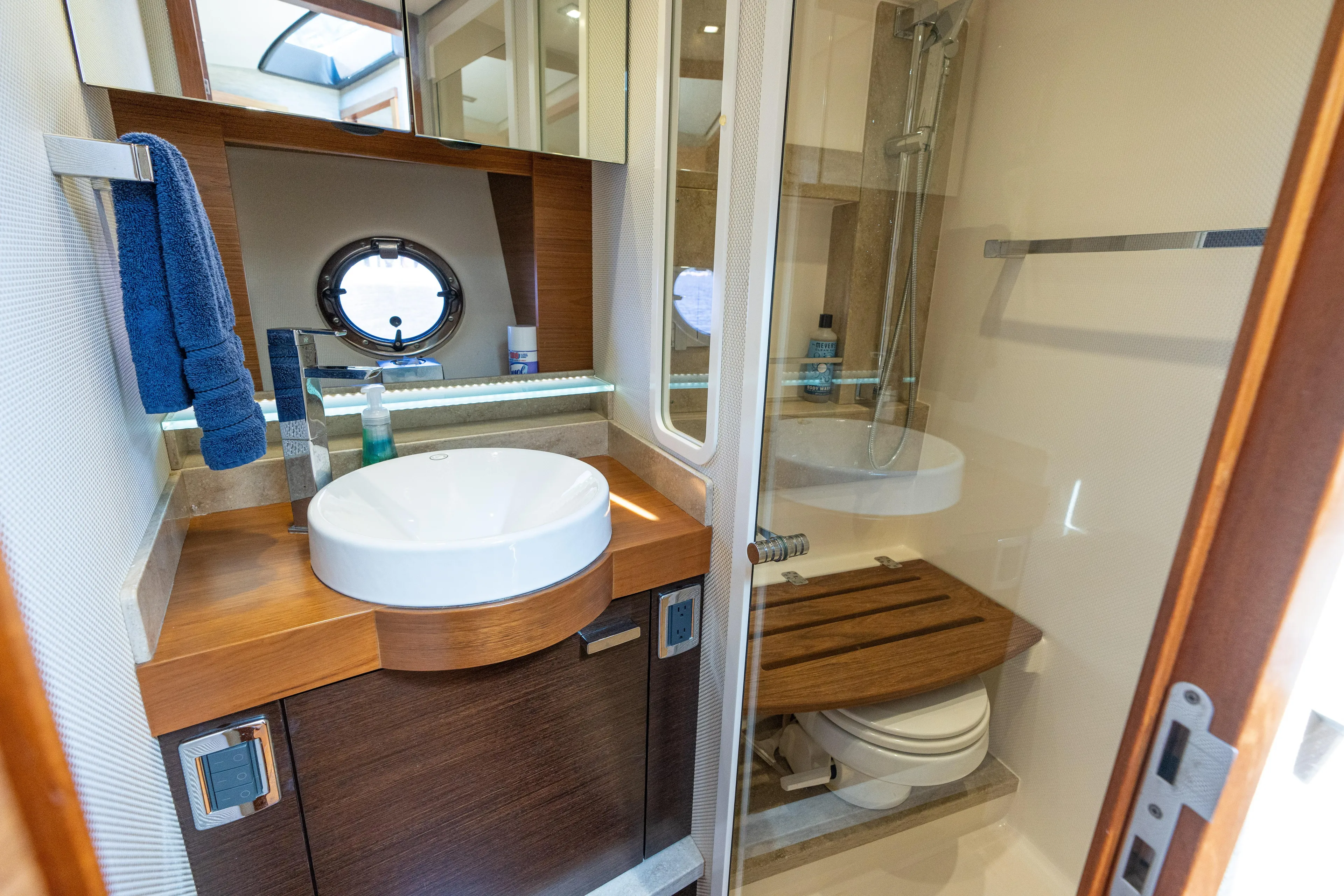 Pyrite Yacht Photos Pics Luxurious bathroom in 2015 Tiara Yachts C44 Coupe with modern fixtures and porthole window.