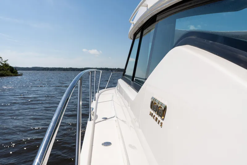 Pyrite Yacht Photos Pics 2015 Tiara Yachts C44 Coupe cruising on a sunny day, showcasing sleek design.