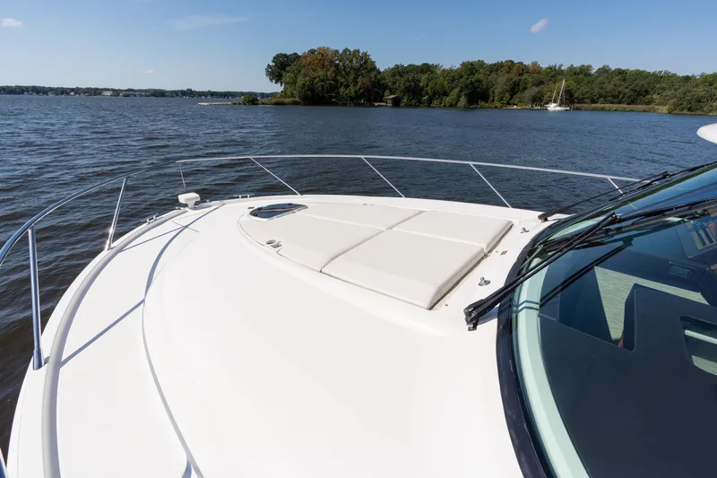 Pyrite Yacht Photos Pics 2015 Tiara Yachts C44 Coupe on serene lake with lush shoreline.