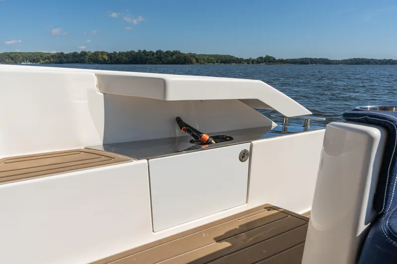 Pyrite Yacht Photos Pics 2015 Tiara Yachts C44 Coupe deck with storage compartment, overlooking serene waters.