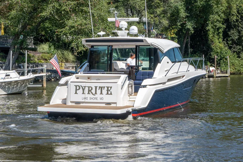 Pyrite Yacht Photos Pics 2015 Tiara Yachts C44 Coupe cruising on a scenic waterway.