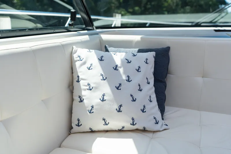 Pyrite Yacht Photos Pics Cushioned seating on 2015 Tiara Yachts C44 Coupe with anchor-patterned pillow.