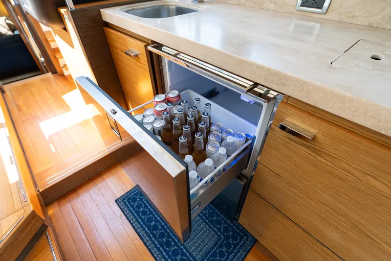 Pyrite Yacht Photos Pics Open drawer fridge in 2015 Tiara Yachts C44 Coupe galley, stocked with beverages.