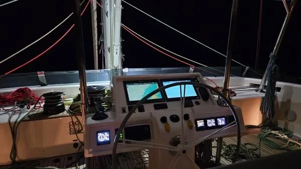 Little Giant Yacht Photos Pics Cockpit of 2017 Sunreef 88 DD yacht at night, featuring navigation controls and ropes.