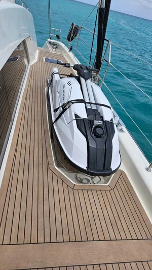 Little Giant Yacht Photos Pics Luxury Sunreef 88 DD yacht deck with jet ski, 2017 model, on turquoise sea.