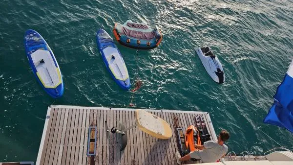 Little Giant Yacht Photos Pics Man on Sunreef 88 DD yacht with paddleboards and inflatable raft, 2017 model.